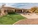 Landscaped backyard with artificial turf and patio at 42034 N Harbour Town Ct, Anthem, AZ 85086