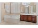 Bathroom with soaking tub, double vanity and window at 42034 N Harbour Town Ct, Anthem, AZ 85086