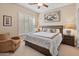 Spacious bedroom with king-size bed and sitting area at 42034 N Harbour Town Ct, Anthem, AZ 85086