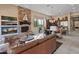 Open concept Gathering room with stone fireplace and kitchen views at 42034 N Harbour Town Ct, Anthem, AZ 85086
