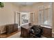 Spacious home office with built-in desk and view of dining room at 42034 N Harbour Town Ct, Anthem, AZ 85086