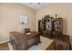 Home office with large desk, built-in shelving, and wood flooring at 42034 N Harbour Town Ct, Anthem, AZ 85086