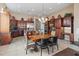 Spacious kitchen with dark wood cabinets and an island at 42034 N Harbour Town Ct, Anthem, AZ 85086