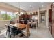 Kitchen with breakfast nook, dark wood cabinets and granite counters at 42034 N Harbour Town Ct, Anthem, AZ 85086