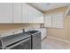 Laundry room with washer, dryer, and cabinets at 42034 N Harbour Town Ct, Anthem, AZ 85086