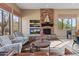 Cozy living room featuring a stone fireplace and comfortable seating at 42034 N Harbour Town Ct, Anthem, AZ 85086