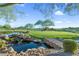 Serene water feature with waterfall and bridge, overlooking golf course at 42034 N Harbour Town Ct, Anthem, AZ 85086