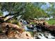 Serene waterfall feature in a landscaped community setting at 42034 N Harbour Town Ct, Anthem, AZ 85086