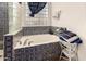 Bathroom with a bathtub, tiled walls, and a window at 4293 S Columbine Way, Gold Canyon, AZ 85118