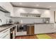 Modern kitchen with white cabinets, stainless steel appliances, and tile backsplash at 4422 N 75Th St # 7009, Scottsdale, AZ 85251