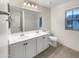 Bathroom with double sinks, large mirror and toilet at 4738 E Tierra Buena Ln, Phoenix, AZ 85032