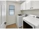 Laundry room with washer, dryer and overhead cabinets at 4738 E Tierra Buena Ln, Phoenix, AZ 85032