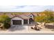 Single-story house with two-car garage and desert landscaping at 47970 N Navidad Ct, Gold Canyon, AZ 85118