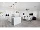 Modern kitchen with white cabinets, marble island, and stainless steel appliances at 47970 N Navidad Ct, Gold Canyon, AZ 85118