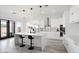 Modern kitchen with white cabinets, marble island, and stainless steel appliances at 47970 N Navidad Ct, Gold Canyon, AZ 85118