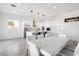 Modern white kitchen with marble island and dining area at 47970 N Navidad Ct, Gold Canyon, AZ 85118