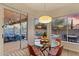 Bright dining area with glass table and chairs, offering views of the backyard and pool at 7283 E Bent Tree Dr, Scottsdale, AZ 85266