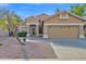 Tan one-story house with a two-car garage and desert landscaping at 9665 E Friess Dr, Scottsdale, AZ 85260