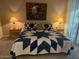 King-size bed with navy and white quilt and night stands at 9708 E Via Linda -- # 2322, Scottsdale, AZ 85258
