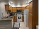 Bright kitchen with wood cabinets, white appliances, and a tile floor at 9708 E Via Linda -- # 2322, Scottsdale, AZ 85258