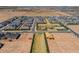 Overhead view of a new community under construction with various stages of home development and a central green space at 11029 E Ulysses Ave, Mesa, AZ 85212