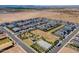 Aerial view of a Primary-planned community showcasing homes and a central community park with amenities at 11029 E Ulysses Ave, Mesa, AZ 85212