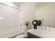 Bathroom features a tub and shower combination, dark wood vanity, white sink, and decorative accents at 11029 E Ulysses Ave, Mesa, AZ 85212