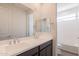 Bathroom featuring double sinks, large mirror and bath with shower at 11029 E Ulysses Ave, Mesa, AZ 85212