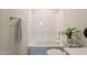 Bright bathroom featuring a tub with a shower, plant accents, and a towel rack at 11029 E Ulysses Ave, Mesa, AZ 85212