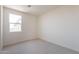 Bright bedroom featuring neutral carpeting and a window for natural light at 11029 E Ulysses Ave, Mesa, AZ 85212