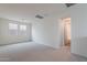 Bright bedroom features neutral carpet, two windows and access to ensuite bathroom at 11029 E Ulysses Ave, Mesa, AZ 85212