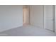 Bedroom view with a door to another room and neutral carpet at 11029 E Ulysses Ave, Mesa, AZ 85212