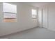 Bright bedroom with neutral walls and carpet and dual windows with views to the neighborhood at 11029 E Ulysses Ave, Mesa, AZ 85212