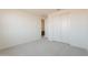 An empty bedroom with neutral carpet featuring a closet with sliding doors at 11029 E Ulysses Ave, Mesa, AZ 85212