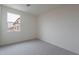 Bright bedroom with neutral walls and carpet with a window providing views to the neighborhood at 11029 E Ulysses Ave, Mesa, AZ 85212