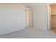 Neutral carpeted bedroom showing entry and closet doors at 11029 E Ulysses Ave, Mesa, AZ 85212