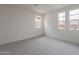 Bright bedroom with neutral walls and carpet with two windows providing exterior views at 11029 E Ulysses Ave, Mesa, AZ 85212