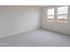 Bright bedroom with neutral walls and carpet and two windows providing ample natural light at 11029 E Ulysses Ave, Mesa, AZ 85212