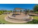 A shaded common area with comfortable seating and fire pit, perfect for gatherings at 11029 E Ulysses Ave, Mesa, AZ 85212