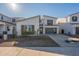 Contemporary two-story home featuring a two-car garage, modern windows, and low maintenance landscaping at 11029 E Ulysses Ave, Mesa, AZ 85212