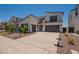 Contemporary home with a concrete driveway, two car garage, and desert landscaping at 11029 E Ulysses Ave, Mesa, AZ 85212