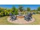 Outdoor fire pit surrounded by Adirondack chairs and mature plants for relaxing evenings at 11029 E Ulysses Ave, Mesa, AZ 85212
