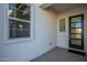 Inviting front porch with modern door, complementing the home's architecture at 11029 E Ulysses Ave, Mesa, AZ 85212