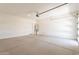 Spacious garage featuring a water heater and access door at 11029 E Ulysses Ave, Mesa, AZ 85212