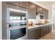 Sleek kitchen with stainless steel appliances, dark cabinets, white countertops, and gas cooktop at 11029 E Ulysses Ave, Mesa, AZ 85212