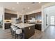Spacious kitchen with large island, seating, stainless steel appliances, and modern lighting at 11029 E Ulysses Ave, Mesa, AZ 85212