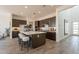 Modern kitchen with a central island, barstool seating, and pendant lighting at 11029 E Ulysses Ave, Mesa, AZ 85212