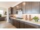 Modern kitchen featuring sleek cabinetry, white countertops, stainless steel appliances, and decorative backsplash at 11029 E Ulysses Ave, Mesa, AZ 85212