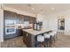 Open concept kitchen featuring a large island with seating, stainless steel appliances, and modern lighting at 11029 E Ulysses Ave, Mesa, AZ 85212