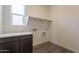 Functional laundry room features modern cabinetry and countertop space at 11029 E Ulysses Ave, Mesa, AZ 85212